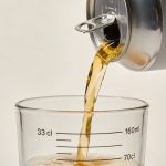 Main versant canette 33 cl dans verre gradué