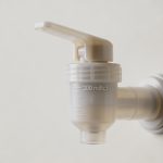 Main verseur doseur en plastique indiquant 300 millilitres